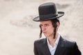 Young hasid pilgrim in the crowd on the city street. Holiday Rosh Hashanah, Jewish New Year.