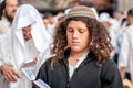 Young hasid pilgrim in the crowd on the city street. Holiday Rosh Hashanah, Jewish New Year.