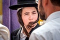 A young Hasid in a traditional Jewish hat and with long payos. Rosh Hashanah, Jewish New Year.