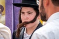 A young Hasid in a traditional Jewish hat and with long payos. Rosh Hashanah, Jewish New Year.