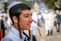 Young hasid in a traditional kippah on the street in a crowd of pilgrims. Rosh Hashanah, Jewish New Year.