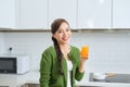 Young healthy asian woman drinking orange juice Royalty Free Stock Photo