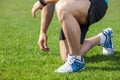 Young healthy athlete has his shoelaces untied