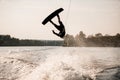 young healthy athletic guy makes incredible somersault on wakeboard Royalty Free Stock Photo