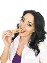 Young Healthy Attractive Woman Eating a Breakfast Cereal Bar Royalty Free Stock Photo