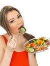 Young Healthy Attractive Woman Eating a Fresh Mixed Garden Salad Royalty Free Stock Photo