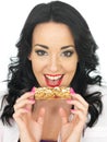 Young Healthy Attractive Woman Holding a Breakfast Cereal Bar Royalty Free Stock Photo