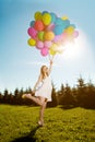 Young healthy beautiful pregnant woman with balloons outdoors. A Royalty Free Stock Photo