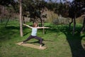 Young healthy caucasian woman doing yoga fitness exercise at Park. Royalty Free Stock Photo