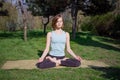 Young healthy caucasian woman doing yoga fitness exercise at Park. Royalty Free Stock Photo