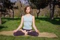 Young healthy caucasian woman doing yoga fitness exercise at Park. Royalty Free Stock Photo