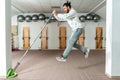 Young healthy fitness man jump with barbell weight bar as exercise for endurance and stamina