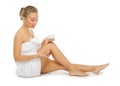 Young healthy girl applying body cream isolated Royalty Free Stock Photo