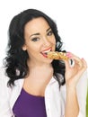 Young Healthy Happy Woman Eating a Breakfast Cereal Bar Royalty Free Stock Photo