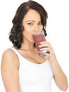 Young Healthy Happy Woman Holding Drinking a Glass of Fresh Mixed Berries Smoothie Royalty Free Stock Photo