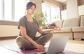 Young healthy indian woman meditate watching online yoga class tutorial at home.