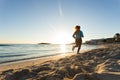 Young healthy lifestyle fitness woman running at sunrise beach Royalty Free Stock Photo