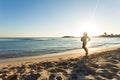 Young healthy lifestyle fitness woman running at sunrise beach Royalty Free Stock Photo