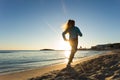 Young healthy lifestyle fitness woman running at sunrise beach Royalty Free Stock Photo