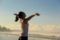 Healthy lifestyle young woman open arms on sunrise seaside beach Royalty Free Stock Photo