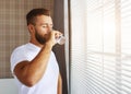 Young healthy man drinking water in morning Royalty Free Stock Photo