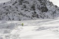 Young healthy sport man running in snow mountains in trail runner hard workout in winter Royalty Free Stock Photo