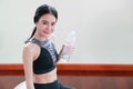 Young healthy and sporty woman drinking water in gym Royalty Free Stock Photo