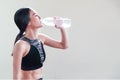 Young healthy and sporty woman drinking water in gym Royalty Free Stock Photo