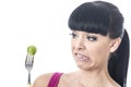 Young Healthy Woman with Disgusted Expression with Distaste to a Brussels Sprout on a Fork