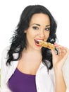 Young Healthy Woman Eating a Breakfast Cereal Bar Royalty Free Stock Photo