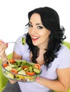 Young Healthy Woman Eating a Fresh Crisp Mixed Garden Salad Royalty Free Stock Photo