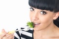 Young Healthy Woman Eating a Healthy Fresh Green Leafed Salad with Tomato