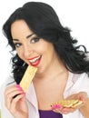 Young Healthy Woman Eating Thin Crispy Crackers