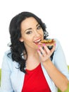 Young Healthy Woman Eating a Wholegrain Cracker with Parma Ham and Sliced Green Olives