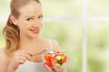 Young healthy woman eats vegetable salad