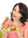 Young Healthy Woman Holding a Cold Cooked Chicken Drumstick Royalty Free Stock Photo