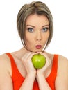 Young Healthy Woman Holding a Fresh Ripe Shiny Green Apple