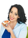 Young Healthy Woman Holding a Wholegrain Cracker with Cottage Cheese and Ripe Fresh Tomato