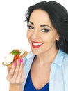Young Healthy Woman Holding a Wholegrain Cracker with Mozzarella Cheese and Fresh Ripe Tomato