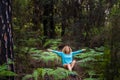Young healthy woman meditate and do yoga position in the middle of a green wild beautiful forest - love earth`s day and planet