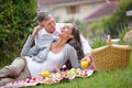 Young at heart. a loving mature couple having a romantic picnic on the grass. Royalty Free Stock Photo