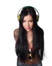 Young heavily tattooed woman Listening to headphones
