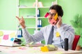 Young help desk operator working in office with many conflicting Royalty Free Stock Photo