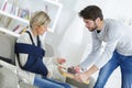 Young helpful man spending time with injured lady