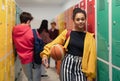 Young high school students meeting and greeting near locker in campus hallway, back to school concept. Royalty Free Stock Photo