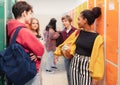 Young high school students meeting and greeting near locker in campus hallway, back to school concept. Royalty Free Stock Photo