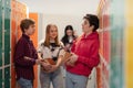 Young high school students meeting and greeting near locker in campus hallway, back to school concept. Royalty Free Stock Photo