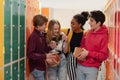 Young high school students meeting and greeting near locker in campus hallway, back to school concept. Royalty Free Stock Photo