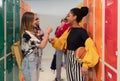 Young high school students meeting and greeting near locker in campus hallway, back to school concept. Royalty Free Stock Photo