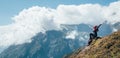 Young hiker backpacker female rising her arms,cheerful laughing and enjoying valley during high altitude Everest Base Camp EBC Royalty Free Stock Photo